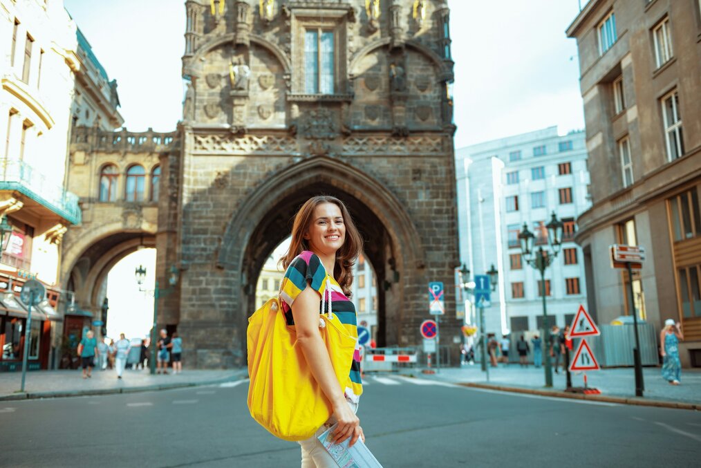 A woman stands and smiles on the street in Germany.